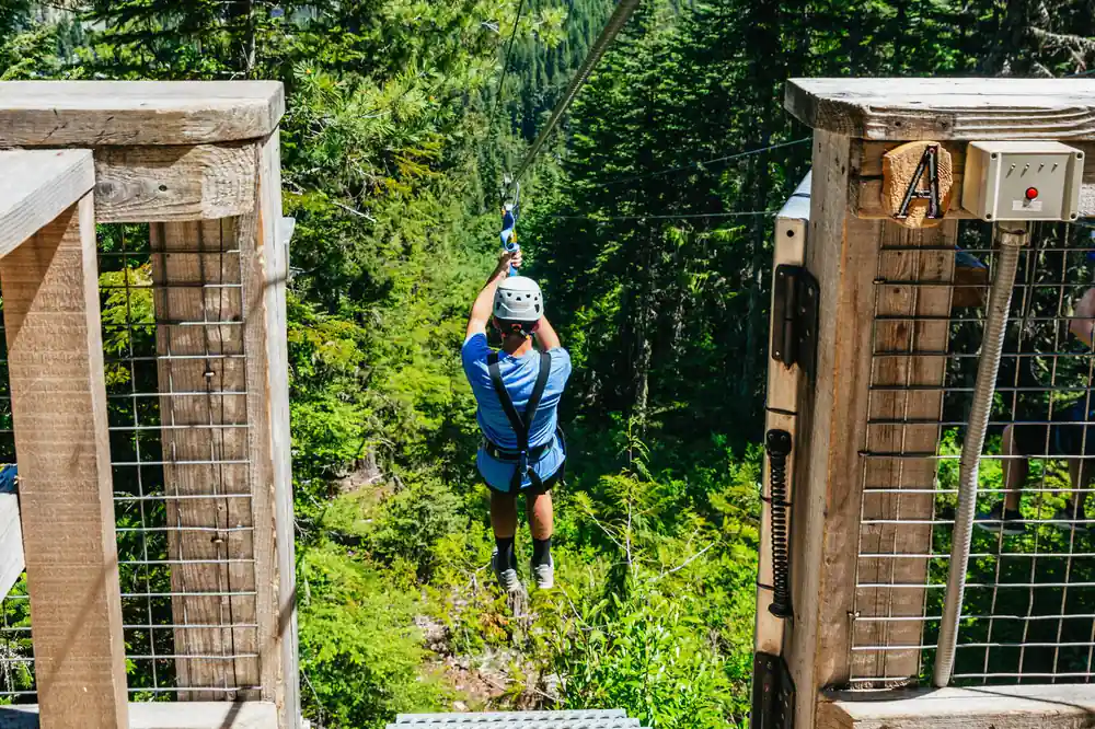 A rider leaving between two timber towers